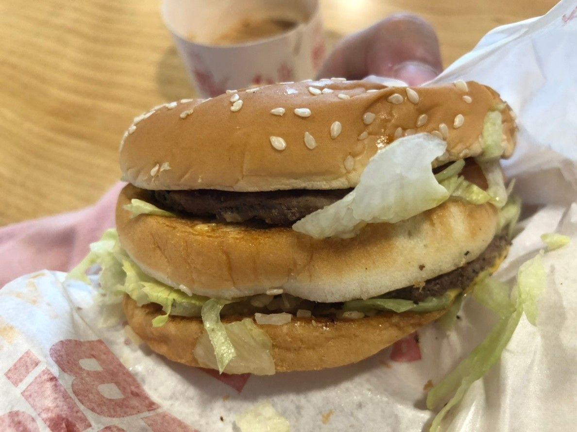 Partially unwrapped McDonald's BIG MAC BLT burger in Korea showing the sesame seed bun.